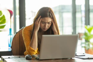 Business Asian woman have a Migraine so headache and stresses have a trouble and problem of her work