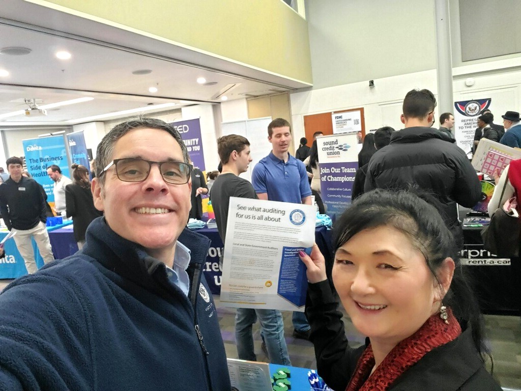 two SAO staffers taking a selfie at a career fair