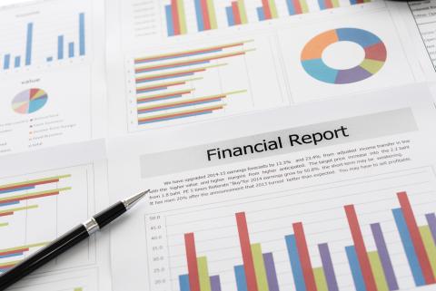 Financial graphs and charts report with pen on desk of business advisor. financial and accounting report concepts.