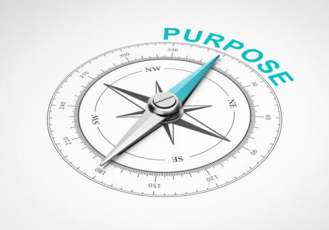 Magnetic Compass with Needle Pointing to Blue Word "Purpose" on White Background