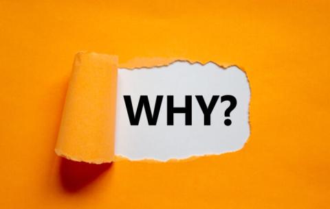 The word "Why?" appearing behind torn orange paper,