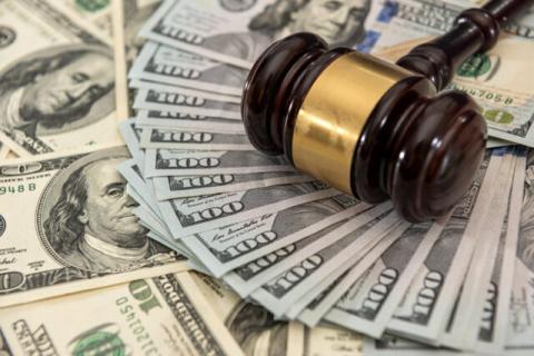 Wooden judge gavel and U.S. money dollar bills