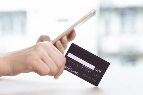 person's hand with credit card