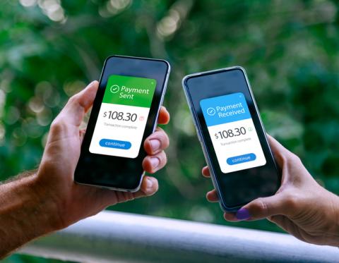 Two cell phones sending and accepting electronic payments