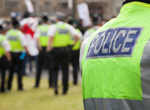 person wearing neon training vest with word POLICE on back