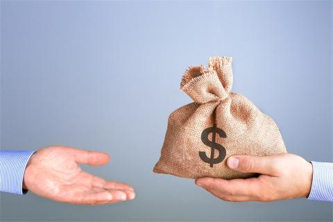 Bag of money going from one hand to another