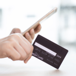 person's hand with credit card