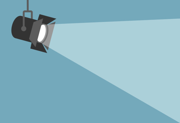 Movie spotlight on blue background.